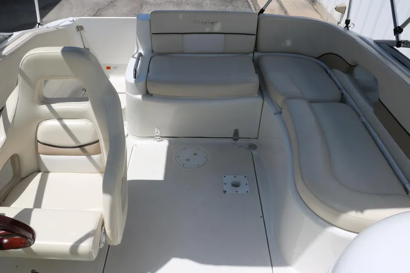 Slide: The Image of 2000 Chris-Craft 232 boat interior with white seating and spacious layout. - 25