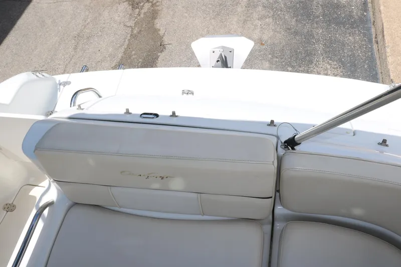 Slide: The Image of Interior of 2000 Chris-Craft 232 boat with white seating and steering wheel. - 26