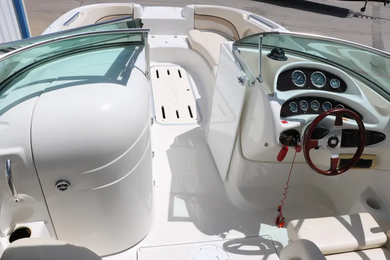 Slide: The Image of Rear seating area of a 2000 Chris-Craft 232 boat with white upholstery. - 27