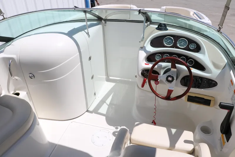 Slide: The Image of Interior of 2000 Chris-Craft 232 boat with steering wheel and seating. - 36