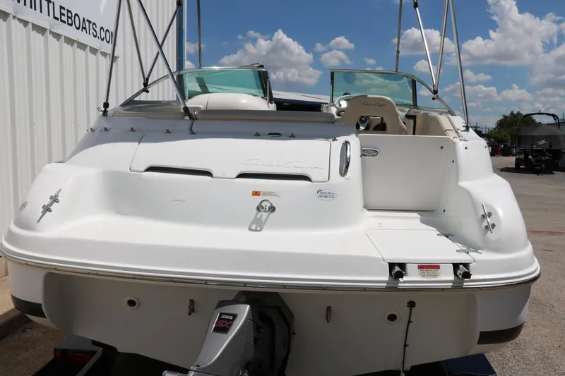 Slide: The Image of 2000 Chris-Craft 232 boat, rear view, white exterior, parked outdoors under blue sky. - 5