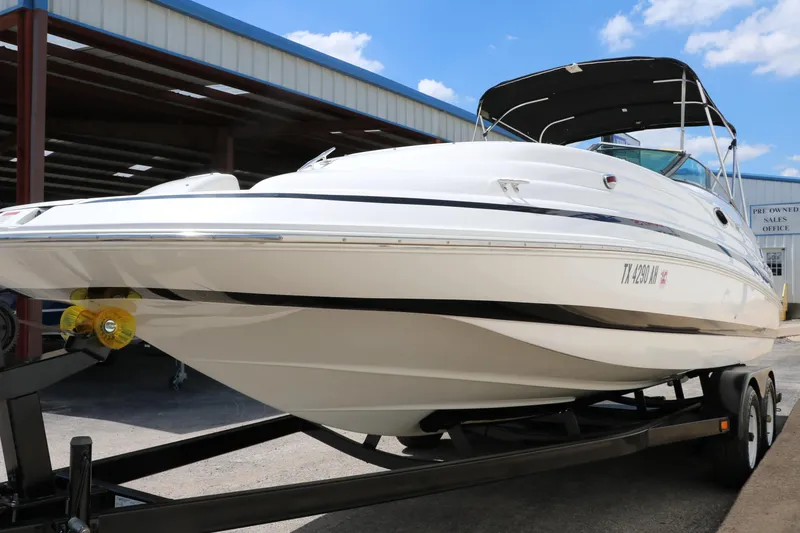 Slide: The Image of 2000 Chris-Craft 232 boat on trailer under blue sky. - 9