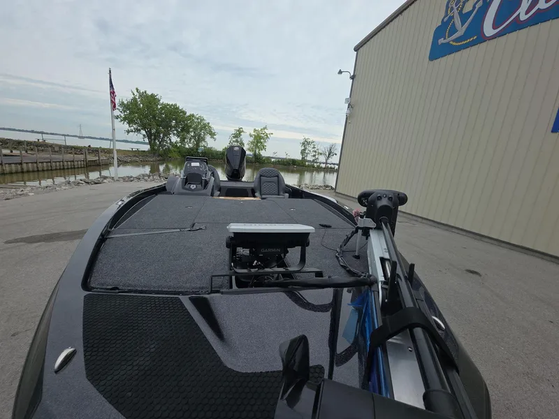 Slide: The Image of 2025 iKon vls20 boat docked near a building, with trees and water in the background. - 10