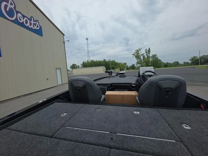 Slide: The Image of 2025 iKon vls20 boat parked near a building under cloudy skies. - 11