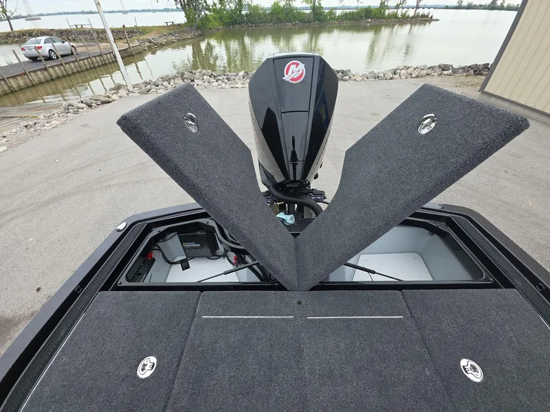 Slide: The Image of 2025 iKon vls20 boat with open storage compartments near a lake. - 22