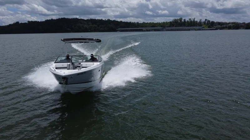 Slide: The Image of 2023 Cobalt R6 boat cruising on a lake under a cloudy sky. - 11