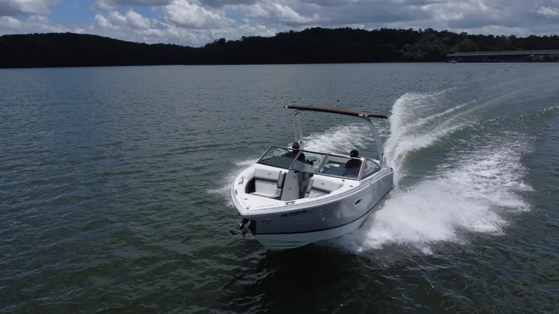 Slide: The Image of 2023 Cobalt R6 boat cruising on a lake under a cloudy sky. - 12