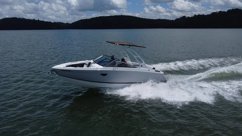 Slide: The Image of 2023 Cobalt R6 boat cruising on a lake under a cloudy sky. - 14