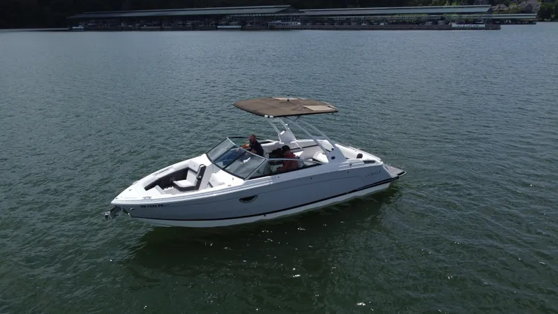 Slide: The Image of 2023 Cobalt R6 boat cruising on a calm lake with a canopy. - 16