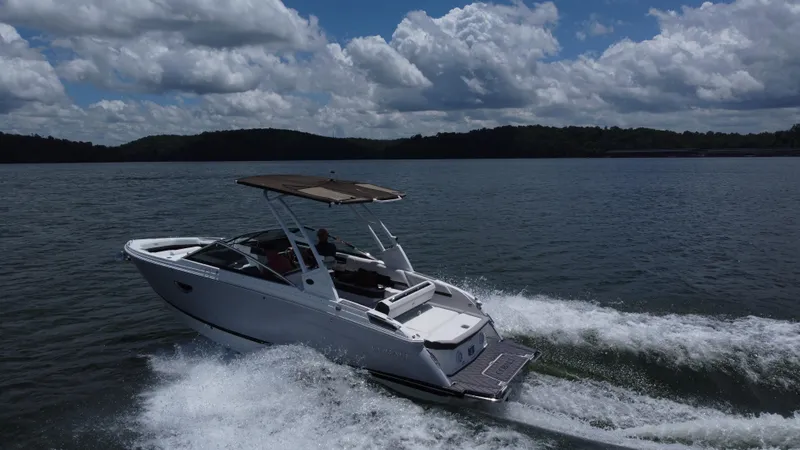 Slide: The Image of 2023 Cobalt R6 boat cruising on a lake under a cloudy sky. - 3