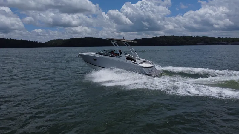 Slide: The Image of 2023 Cobalt R6 boat cruising on a lake under a partly cloudy sky. - 4