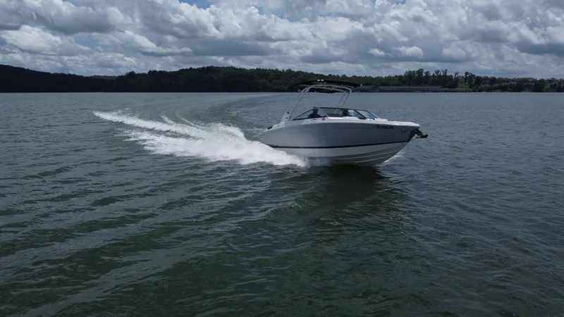 Slide: The Image of 2023 Cobalt R6 boat cruising on a lake under a cloudy sky. - 8