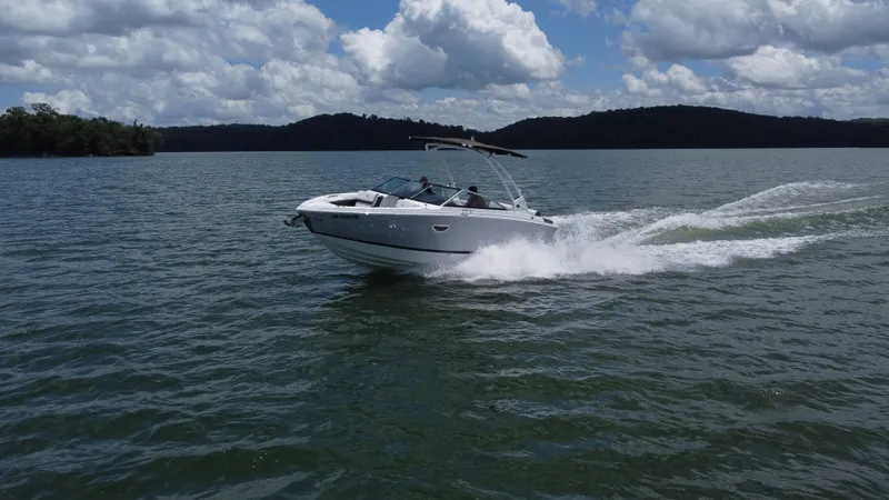 Slide: The Image of 2023 Cobalt R6 boat cruising on a lake under a cloudy sky. - 9