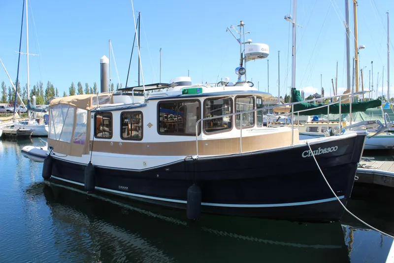 The Image of 2011 Ranger Tugs R-27 boat docked in a marina, featuring a classic design. - 0