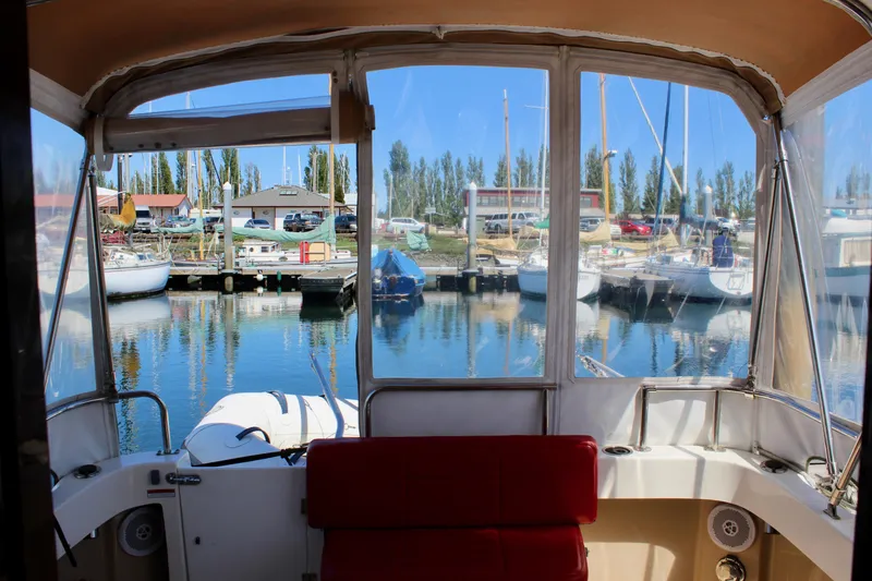 Slide: The Image of Interior view of 2011 Ranger Tugs R-27 boat docked at a marina. - 16