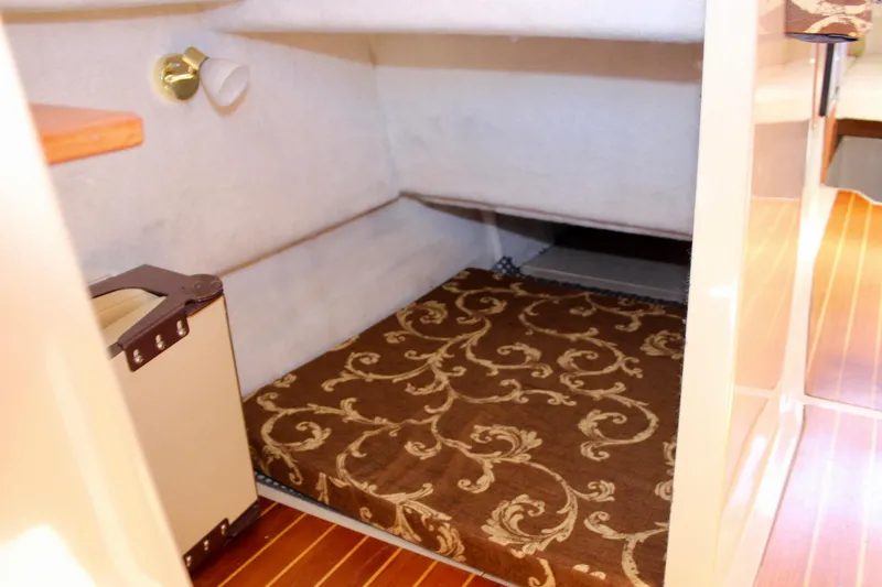 Slide: The Image of 2011 Ranger Tugs R-27 cabin interior with patterned bedding and wooden flooring. - 18