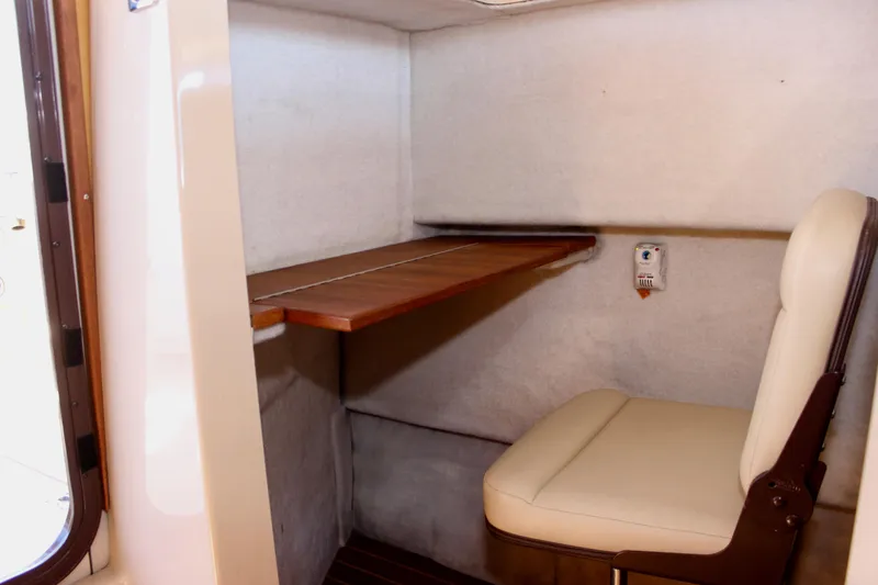 Slide: The Image of Interior cabin of 2011 Ranger Tugs R-27 with seating and foldable table. - 19