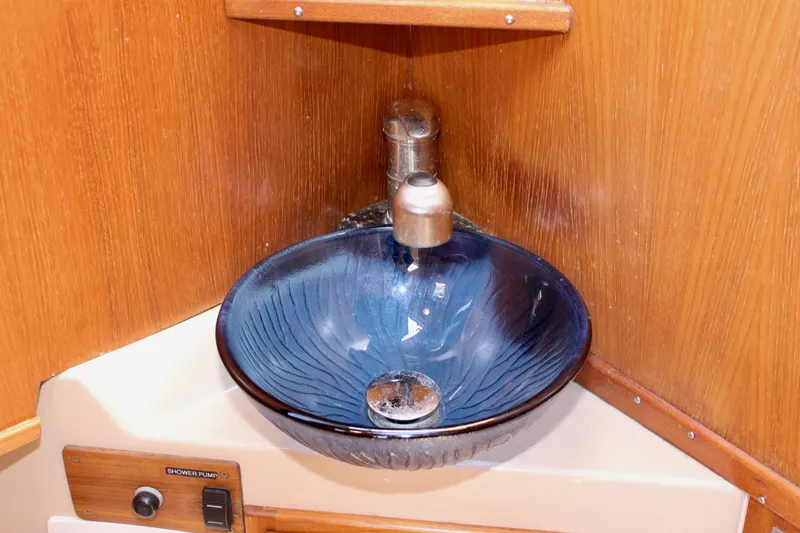 Slide: The Image of Blue glass sink in 2011 Ranger Tugs R-27 boat, wooden interior. - 21