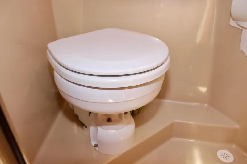 Slide: The Image of 2011 Ranger Tugs R-27 boat bathroom with compact white toilet. - 22