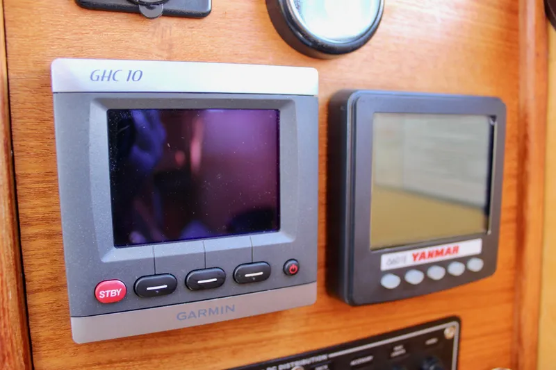 Slide: The Image of Garmin and Yanmar displays on 2011 Ranger Tugs R-27 dashboard. - 34