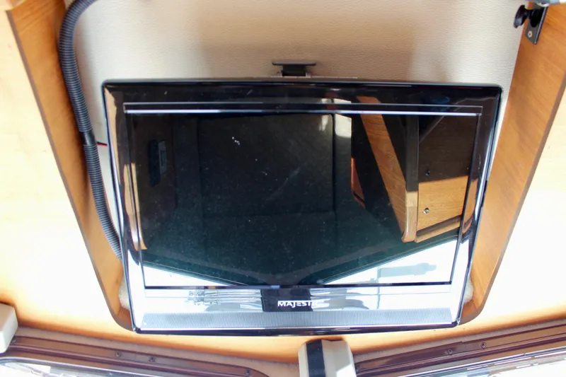 Slide: The Image of Ceiling-mounted TV inside 2011 Ranger Tugs R-27 boat interior. - 43