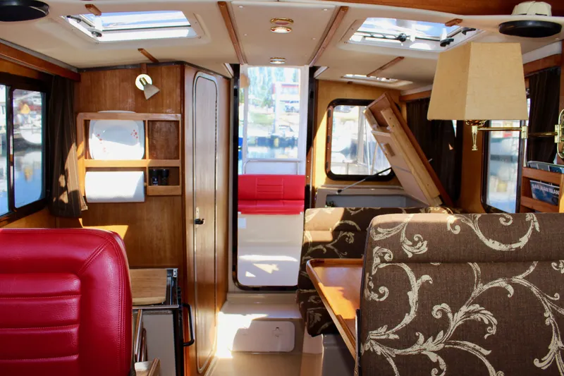 Slide: The Image of Interior of 2011 Ranger Tugs R-27 boat with elegant seating and wood finishes. - 47