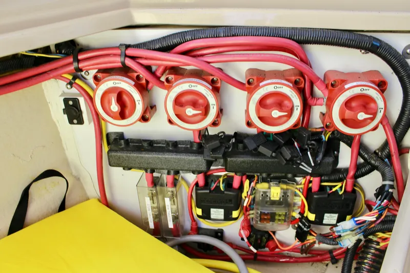 Slide: The Image of Electrical panel of a 2011 Ranger Tugs R-27 boat with red switches and wiring. - 49