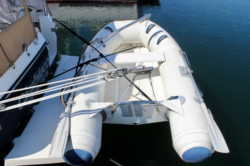 Slide: The Image of Inflatable dinghy attached to a 2011 Ranger Tugs R-27 boat on calm water. - 8