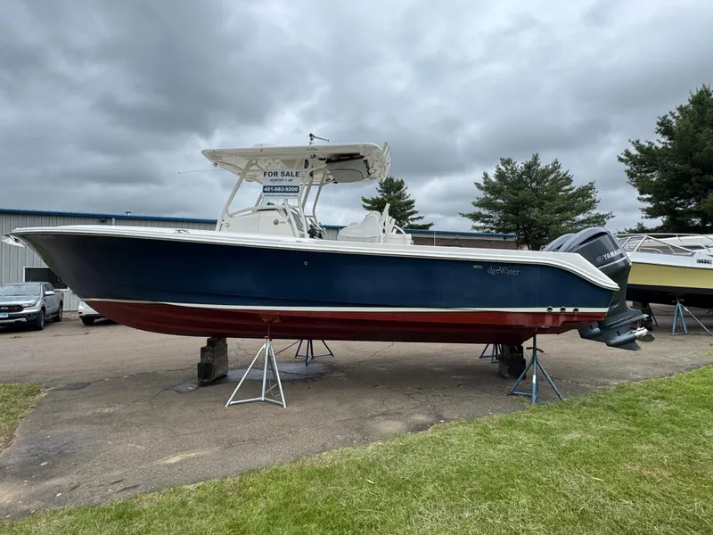 Slide: The Image of 2013 Edgewater 318CC boat on stands, for sale under cloudy skies. - 3