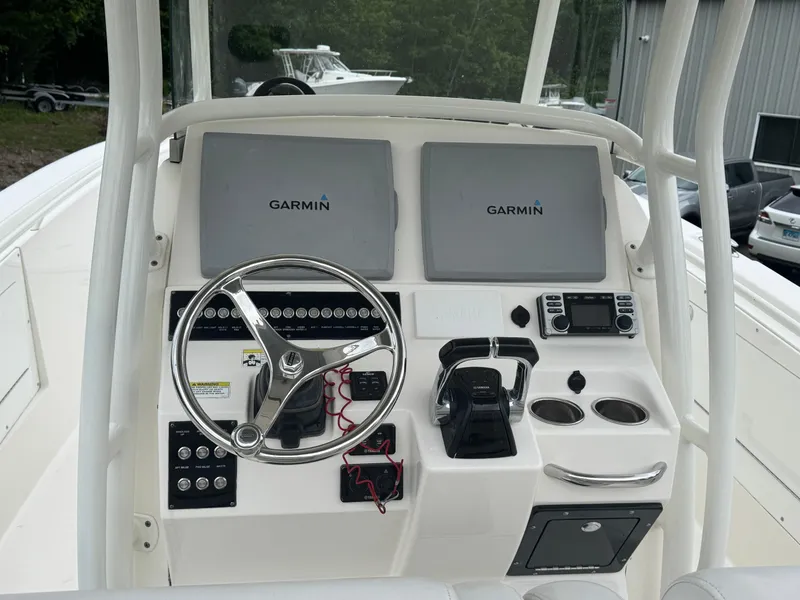 Slide: The Image of 2013 Edgewater 318CC boat dashboard with Garmin displays and steering wheel. - 6