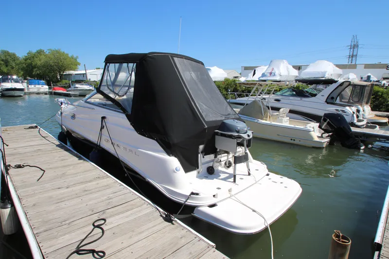 Slide: The Image of 2004 Regal 2665 Commodore boat docked at marina under clear blue sky. - 2