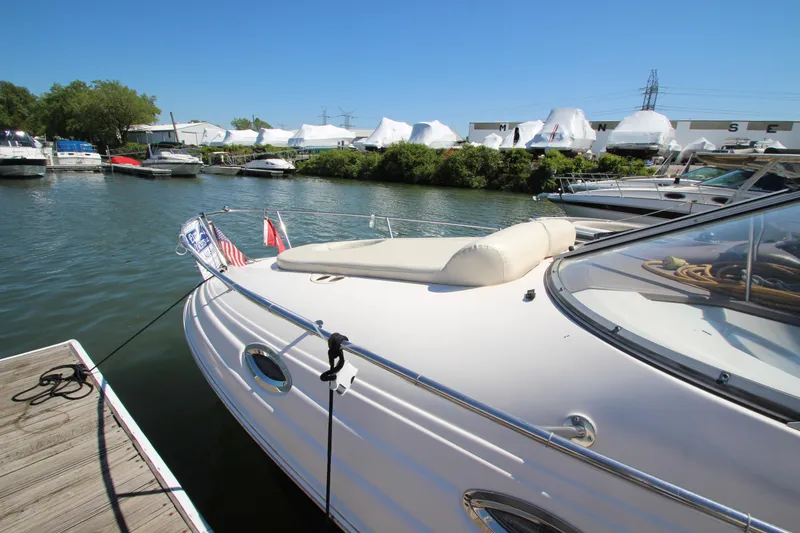 Slide: The Image of 2004 Regal 2665 Commodore boat docked in a marina under clear blue skies. - 3