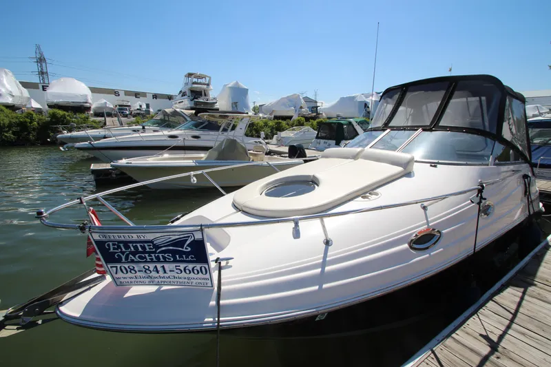 Slide: The Image of 2004 Regal 2665 Commodore yacht docked at marina under clear blue sky. - 4