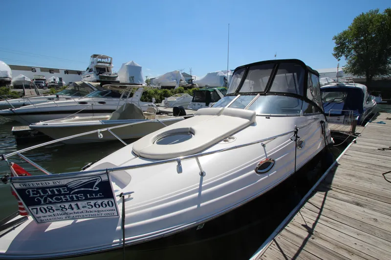 Slide: The Image of 2004 Regal 2665 Commodore yacht docked at marina under clear blue sky. - 5