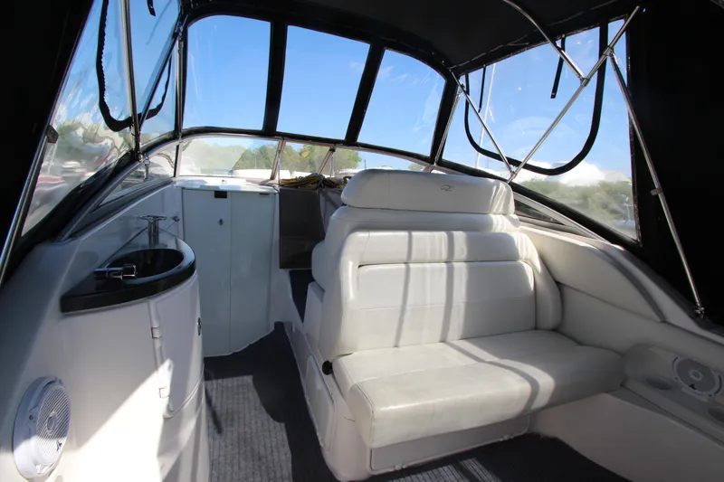 Slide: The Image of 2004 Regal 2665 Commodore boat interior with white seating and black canopy. - 7