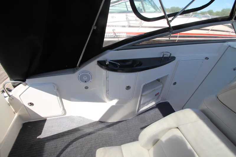 Slide: The Image of 2004 Regal 2665 Commodore boat interior with seating and storage compartments. - 9