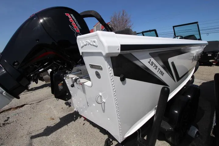 Slide: The Image of 2025 Lund 1975 Tyee boat with powerful outboard motor, side view. - 0