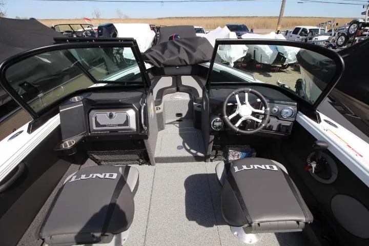 Slide: The Image of Interior of 2025 Lund 1975 Tyee boat with open windshield and branded seats. - 4