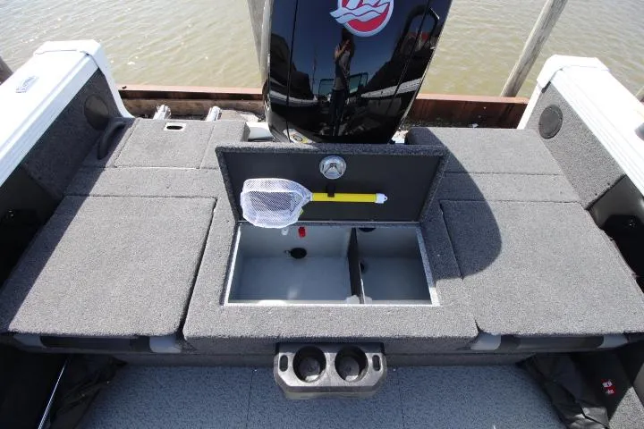 Slide: The Image of 2025 Lund 1975 Tyee boat interior with storage compartment and fishing net. - 8