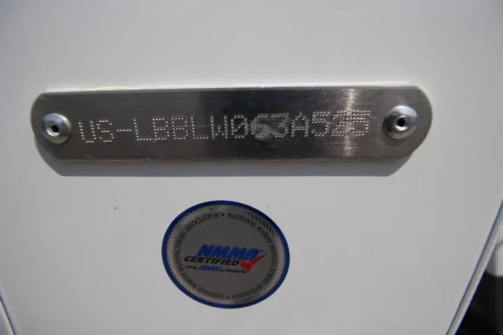 Slide: The Image of Hull identification number on a 2025 Lund 1975 Tyee boat with NMMA certification. - 9