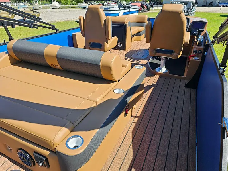 Slide: The Image of 2025 Bentley Pontoons 223 Elite Swingback Tritoon with luxurious tan seating and dual captain chairs. - 10