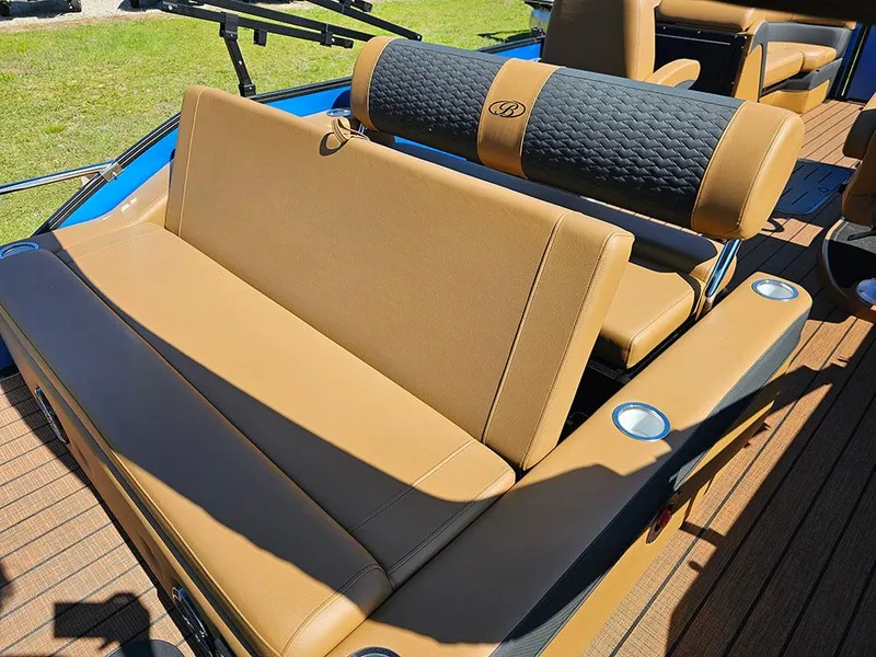 Slide: The Image of 2025 Bentley Pontoons 223 Elite Swingback interior with tan seating and cup holders. - 15