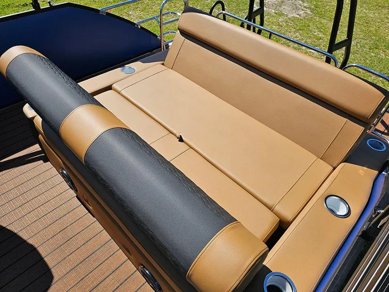 Slide: The Image of 2025 Bentley Pontoons 223 Elite Swingback Tritoon seating area with tan and black upholstery. - 17