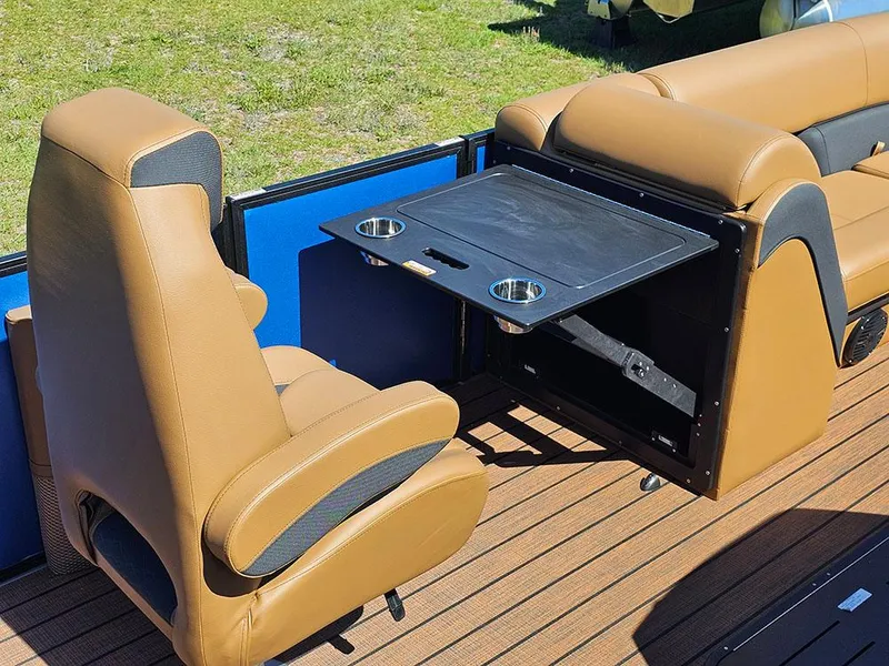 Slide: The Image of 2025 Bentley Pontoons 223 Elite interior with tan seats and foldable table. - 20