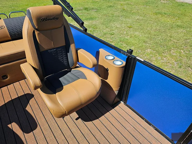 Slide: The Image of 2025 Bentley Pontoons 223 Elite Swingback interior with captain's chair and cup holders. - 21