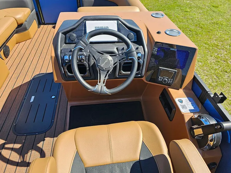 Slide: The Image of 2025 Bentley Pontoons 223 Elite Swingback helm with modern controls and luxurious seating. - 25