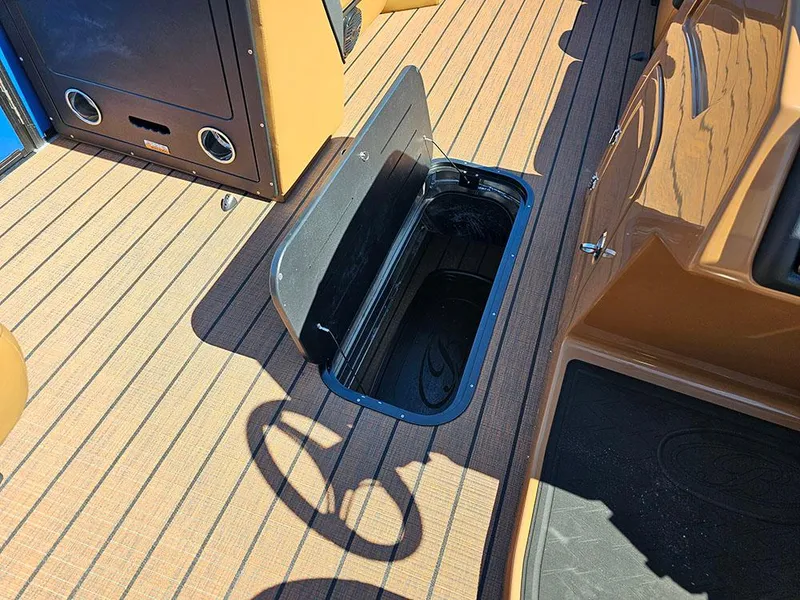 Slide: The Image of 2025 Bentley Pontoons 223 Elite Swingback Tritoon with open storage compartment on deck. - 28