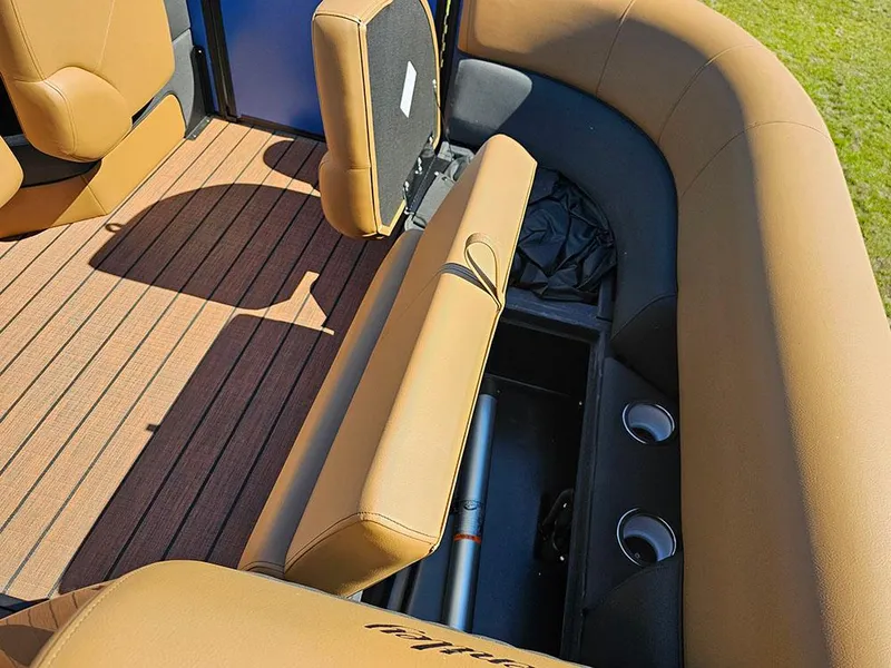 Slide: The Image of 2025 Bentley Pontoons 223 Elite interior with tan seating and storage compartments. - 31