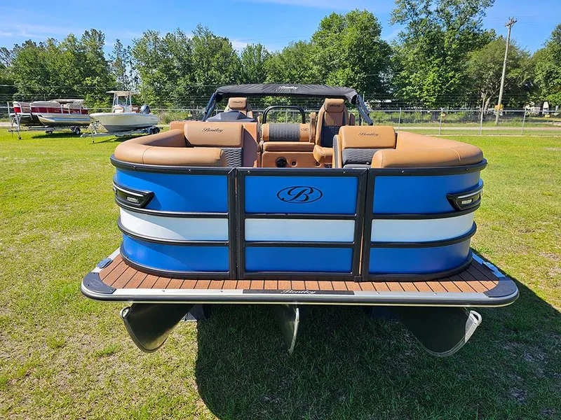 Slide: The Image of 2025 Bentley Pontoons 223 Elite Swingback Dual Captain Full Tritoon on grass, showcasing luxury design. - 4