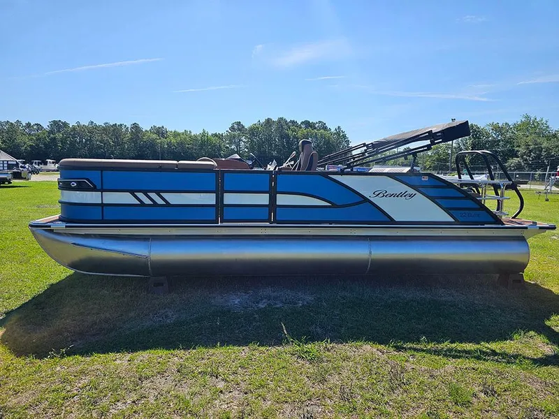 Slide: The Image of 2025 Bentley Pontoons 223 Elite Swingback Dual Captain Full Tritoon on grass under clear sky. - 6